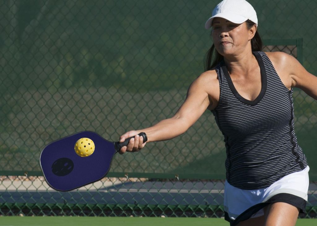 Woman using an eastern forehand grip in pickleball